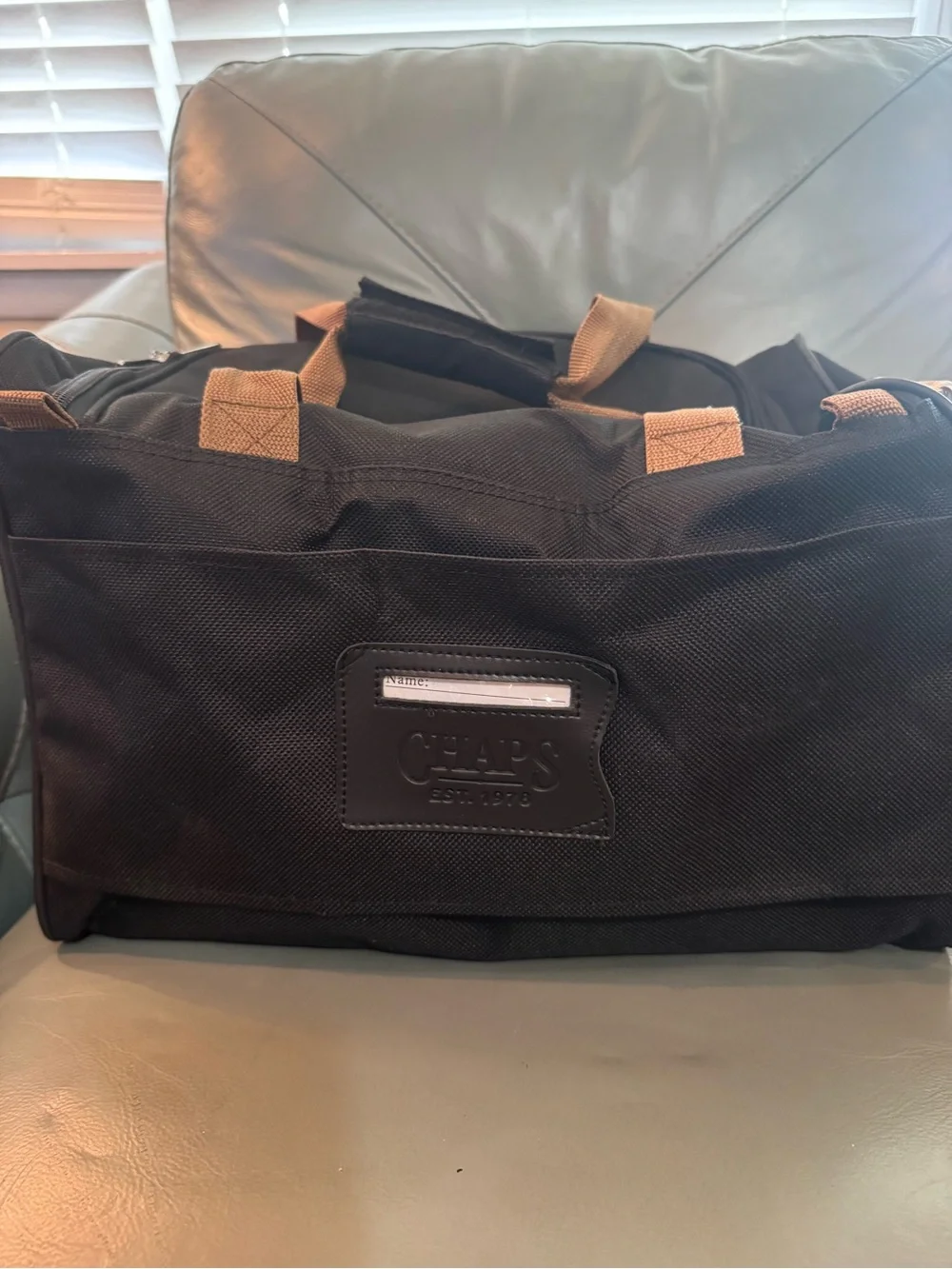 Chaps Black Duffel Bag with Tan Trim shoulder strap and double handle